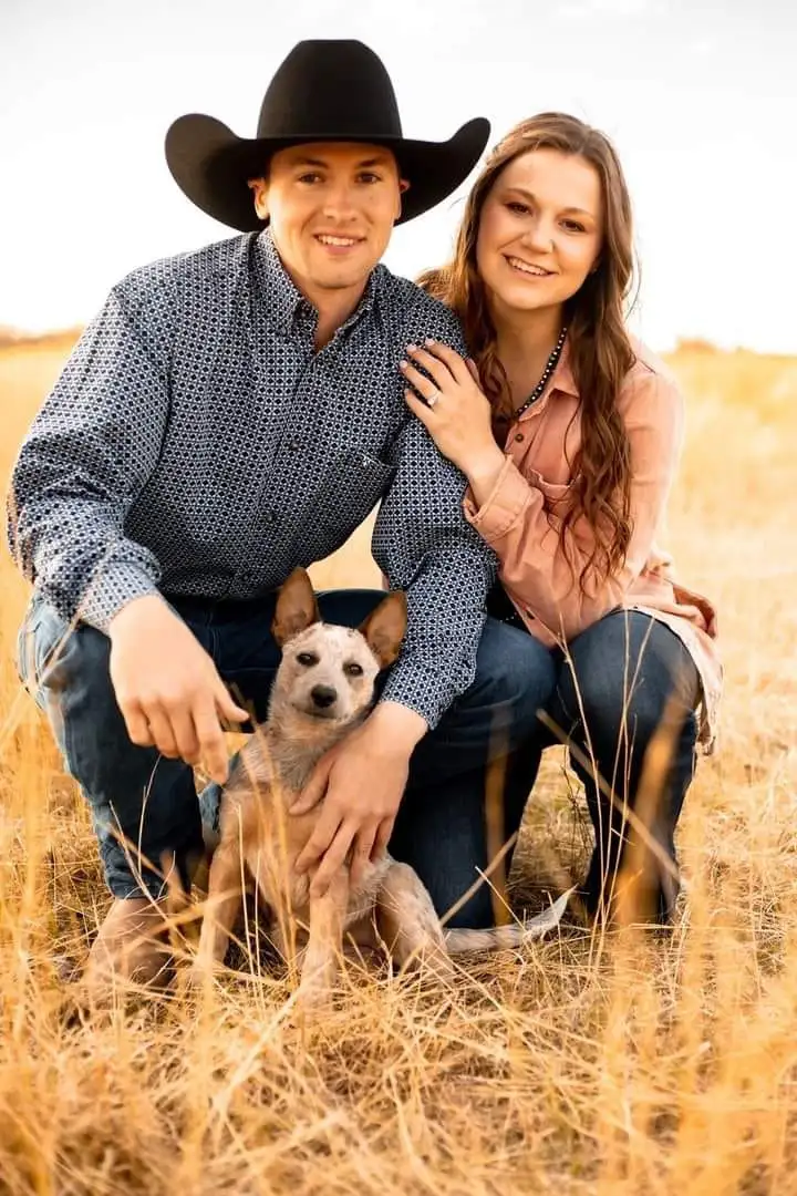 Image of Klay and Kassi Oland with their dog in a pasture